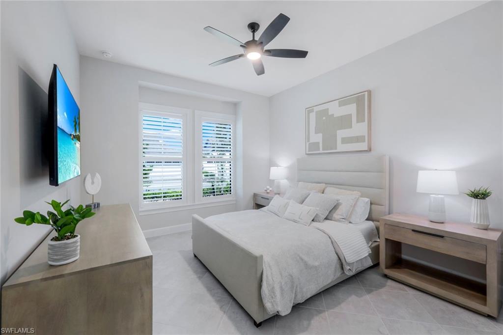 8850 Calypso Court Naples, FL 34113 - Photo 20 of 41 Bedroom #2 with light tile patterned flooring and a ceiling fan