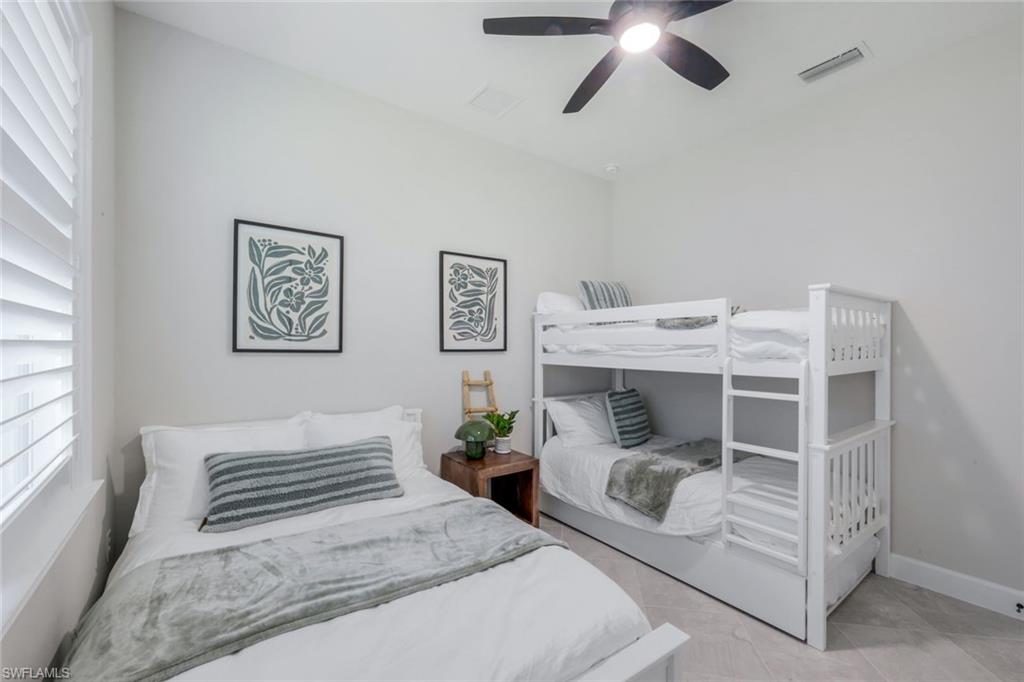 8850 Calypso Court Naples, FL 34113 - Photo 22 of 41 Bedroom #3 featuring full bed, bunk beds, ceiling fan