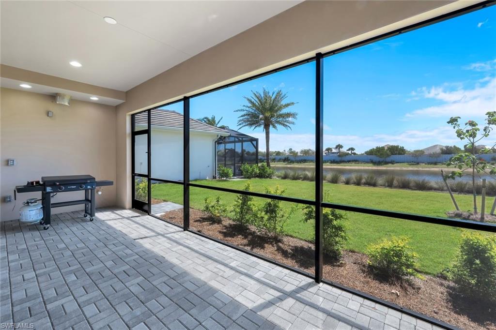 8850 Calypso Court Naples, FL 34113 - Photo 27 of 41 Screened Lanai featuring a water view