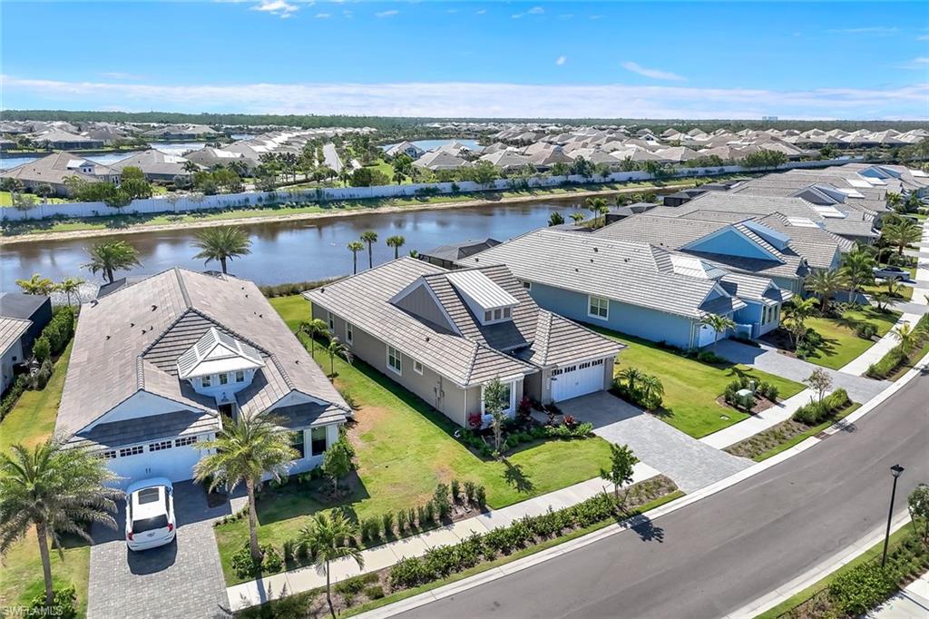 8850 Calypso Court Naples, FL 34113 - Photo 30 of 41 Aerial view of residential area featuring a nearby body of water