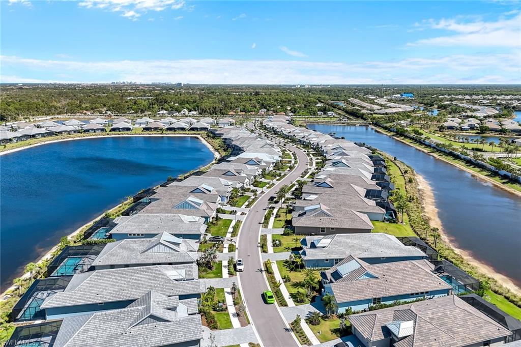 8850 Calypso Court Naples, FL 34113 - Photo 31 of 41 Aerial view of residential area with a large body of water