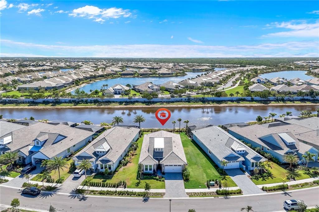8850 Calypso Court Naples, FL 34113 - Photo 34 of 41 Aerial view of residential area with a large body of water