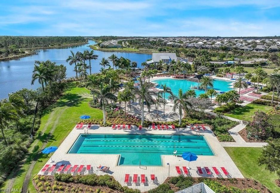 8850 Calypso Court Naples, FL 34113 - Photo 37 of 41 Aerial view of resort pool and a nearby body of water