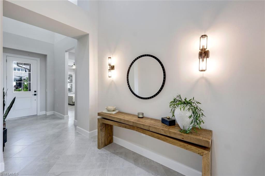 8850 Calypso Court Naples, FL 34113 - Photo 4 of 41 Hall with light tile patterned floors and baseboards