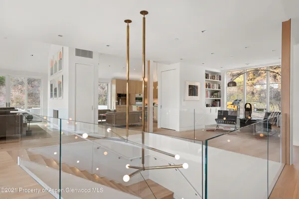 a living room with a large window and furniture