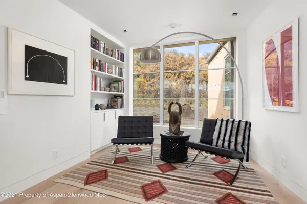 a living room with furniture wooden floor and a flat screen tv