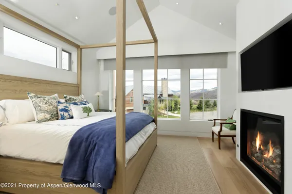 a bedroom with a bed and a large window