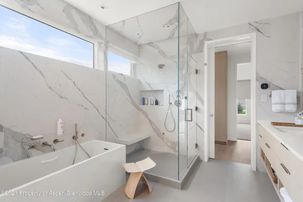a bathroom with a tub a toilet and a sink