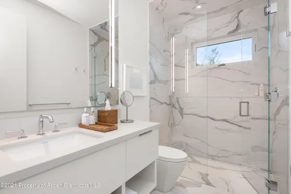 a bathroom with a sink toilet and shower