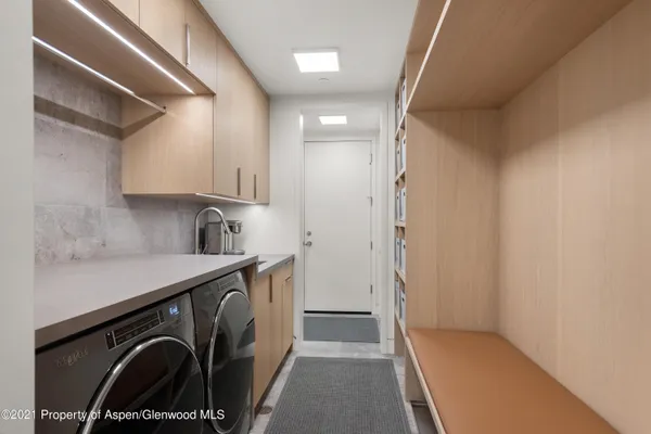 a view of a storage & utility room with a sink