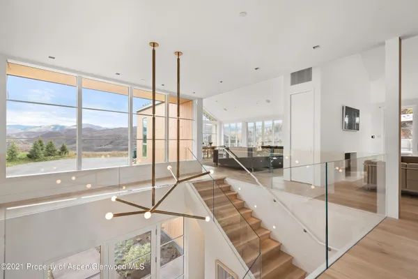 a living room with a large window and furniture