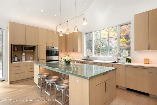 a kitchen with stainless steel appliances granite countertop a sink and a stove