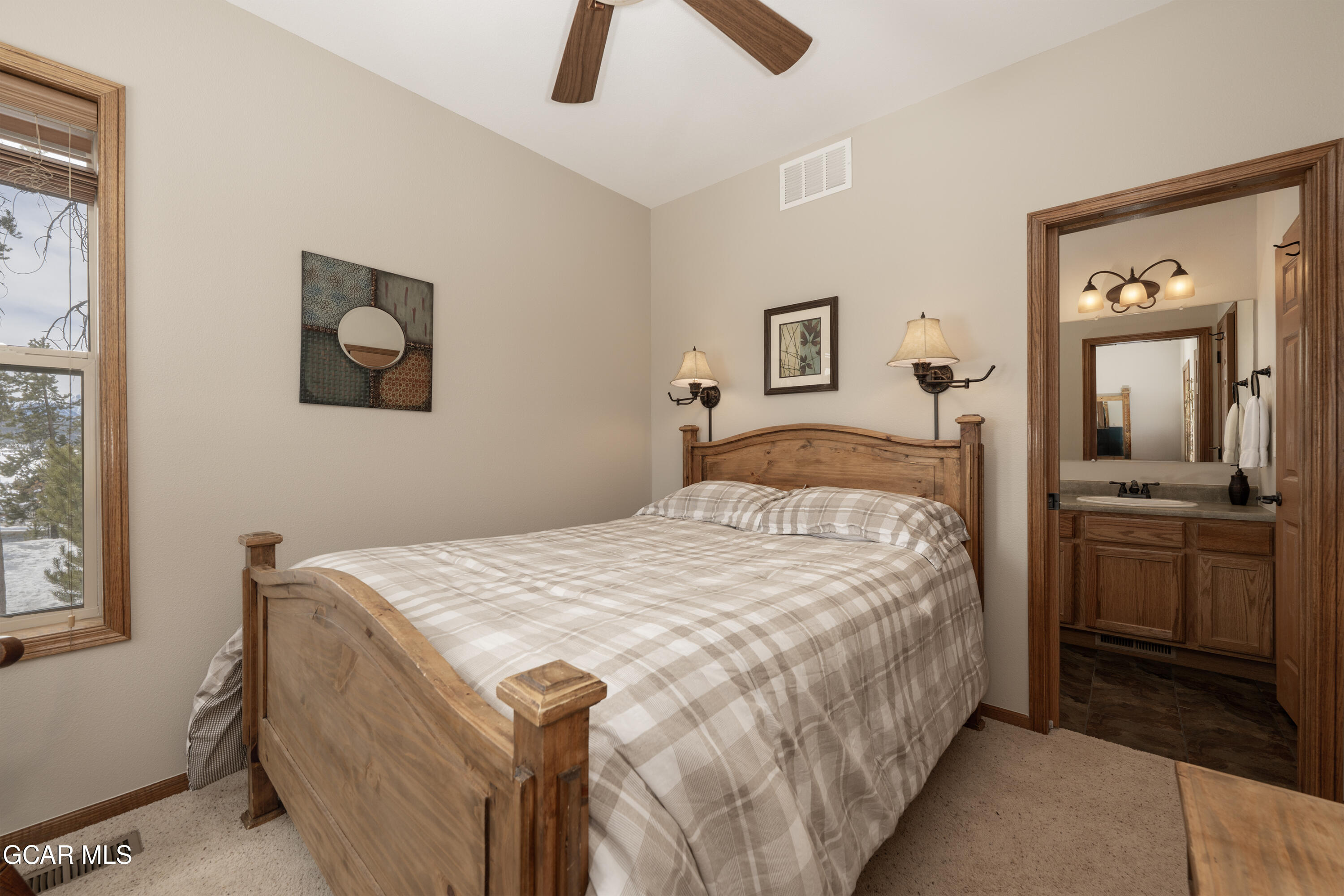 840 Ferret Lane Fraser, CO 80442 - Photo 14 of 33 a bedroom with a bed and a chandelier