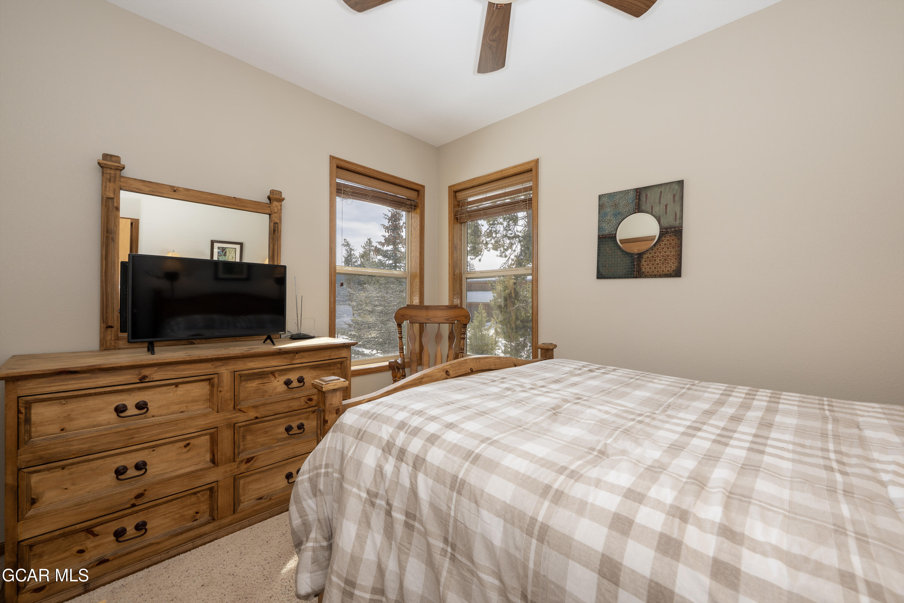 840 Ferret Lane Fraser, CO 80442 - Photo 15 of 33 a bedroom with a bed and a flat screen tv