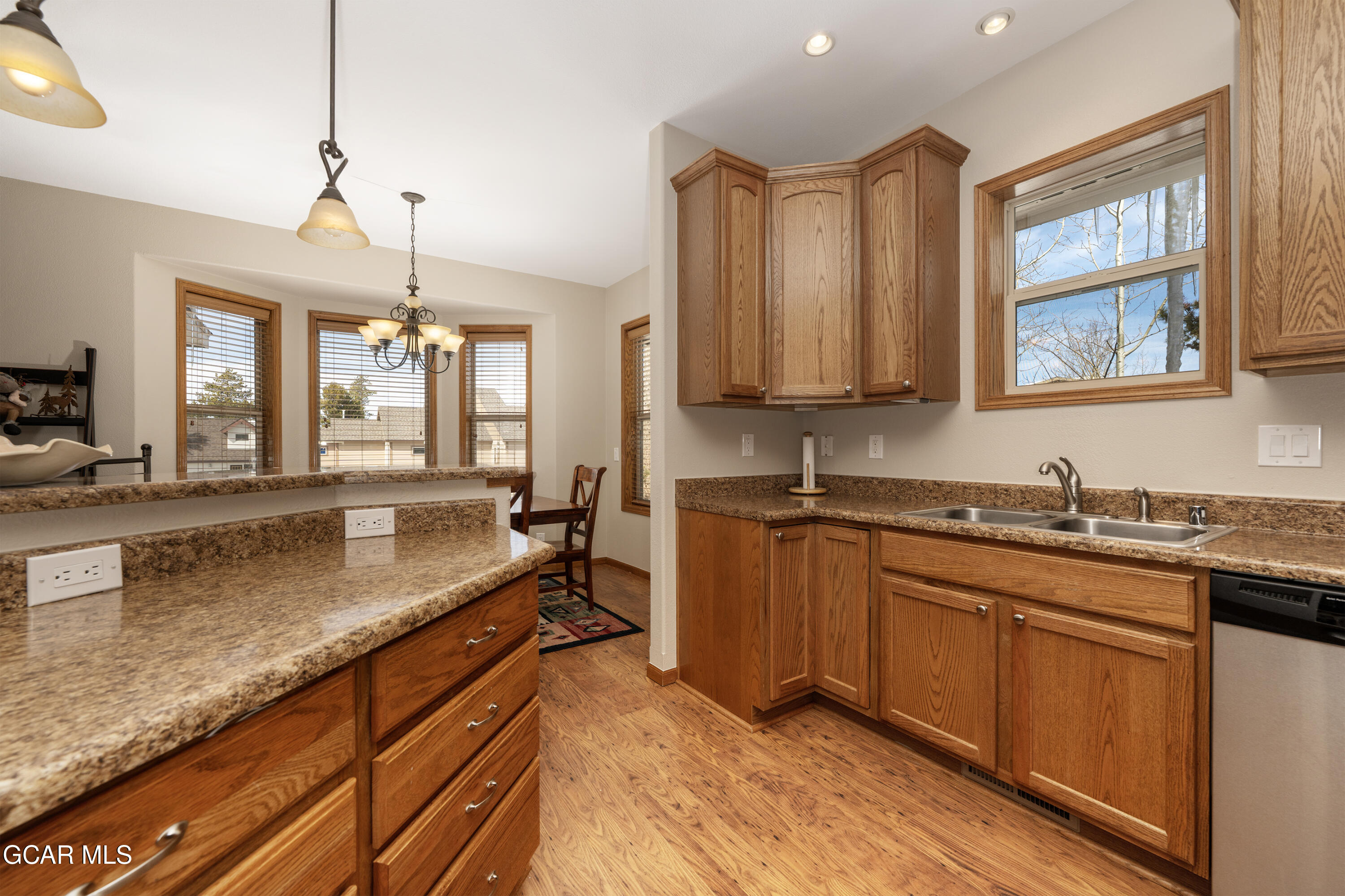 840 Ferret Lane Fraser, CO 80442 - Photo 18 of 33 a kitchen with granite countertop a sink a counter space appliances and cabinets