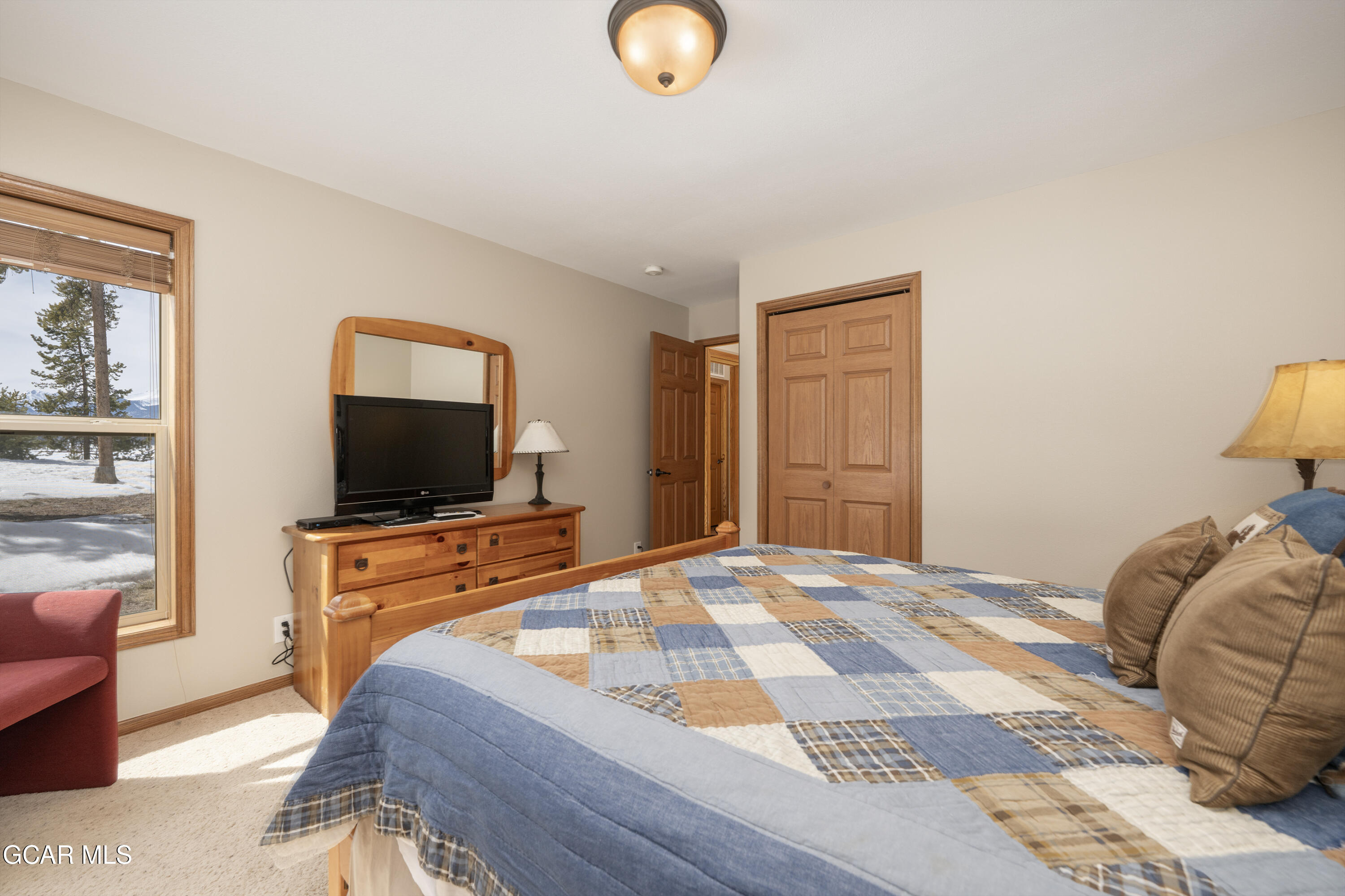 840 Ferret Lane Fraser, CO 80442 - Photo 24 of 33 a bedroom with a bed and a flat screen tv