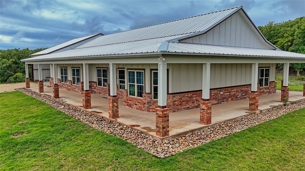 2930 North Greenbrier Road Nocona, TX 76255 - Photo 1 of 40 a front view of a house with porch