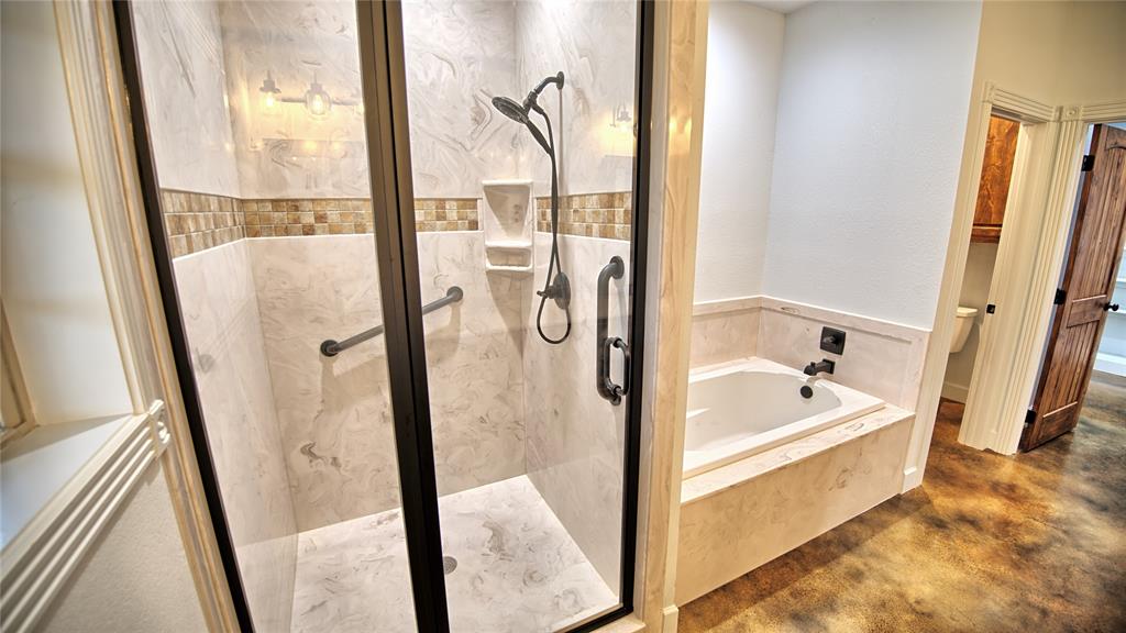 2930 North Greenbrier Road Nocona, TX 76255 - Photo 15 of 40 a bathroom with a bathtub and a shower