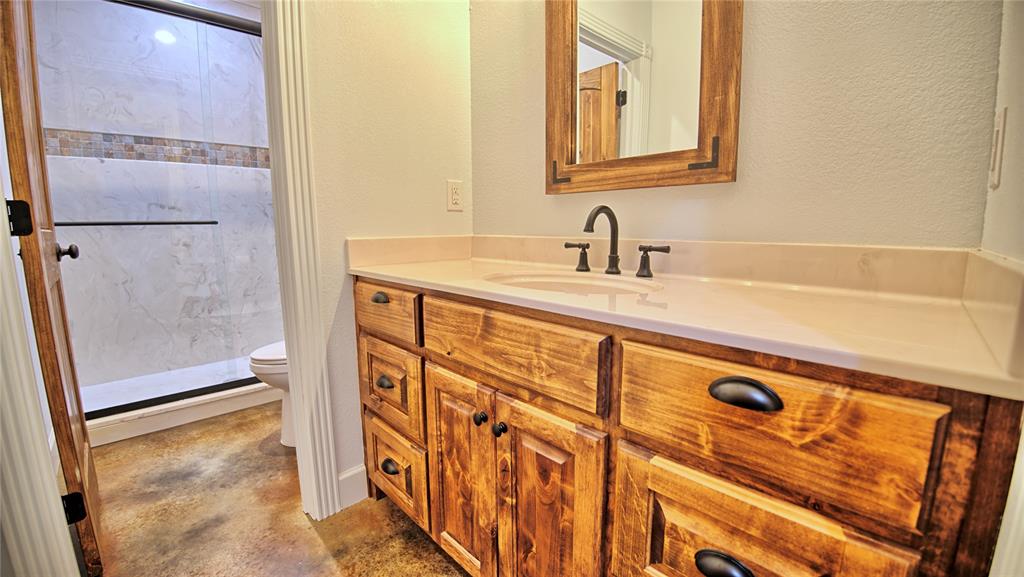 2930 North Greenbrier Road Nocona, TX 76255 - Photo 16 of 40 a bathroom with a sink and a mirror
