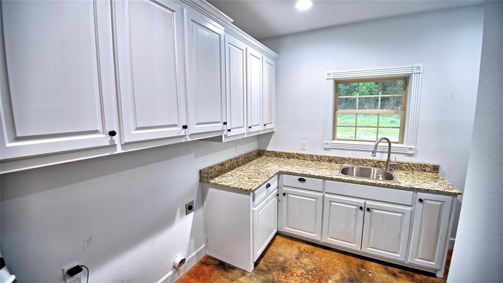 2930 North Greenbrier Road Nocona, TX 76255 - Photo 18 of 40 a kitchen with a sink cabinets and window