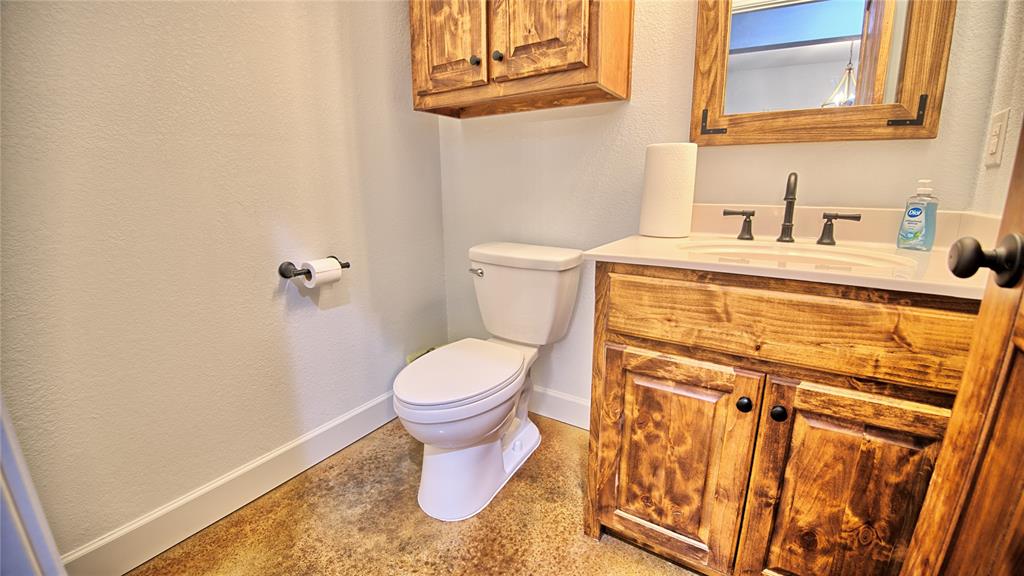 2930 North Greenbrier Road Nocona, TX 76255 - Photo 19 of 40 a bathroom with a toilet and a sink