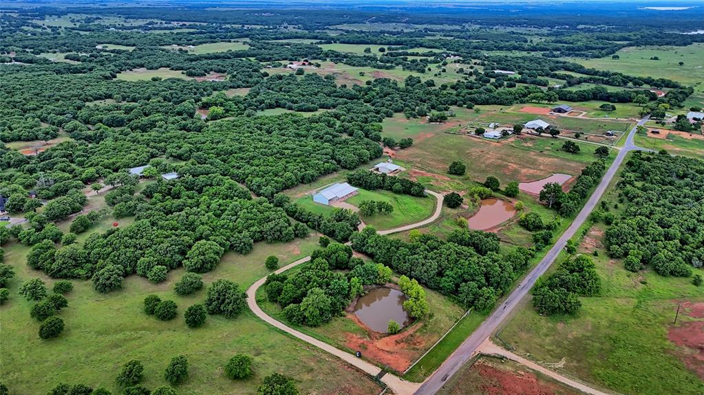 2930 North Greenbrier Road Nocona, TX 76255 - Photo 35 of 40 an aerial view of a residential houses with outdoor space and trees