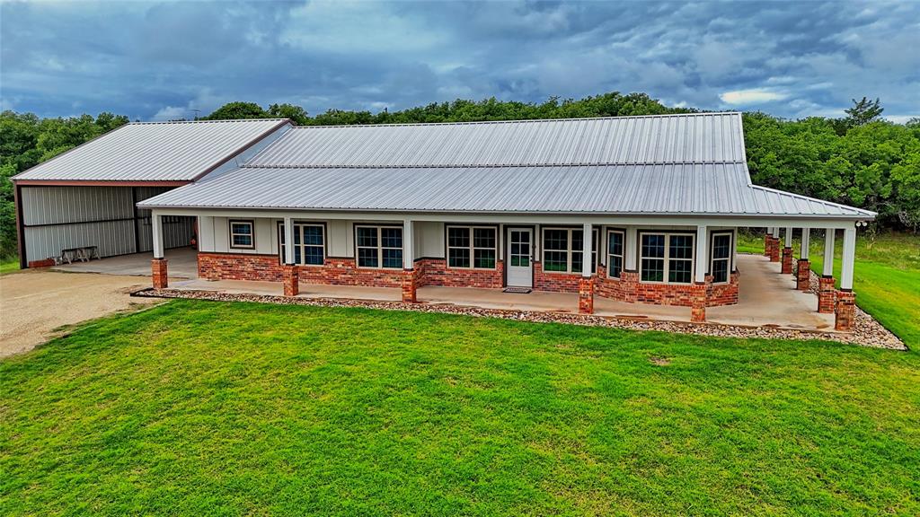 2930 North Greenbrier Road Nocona, TX 76255 - Photo 5 of 40 a view of a house with a backyard porch and sitting area
