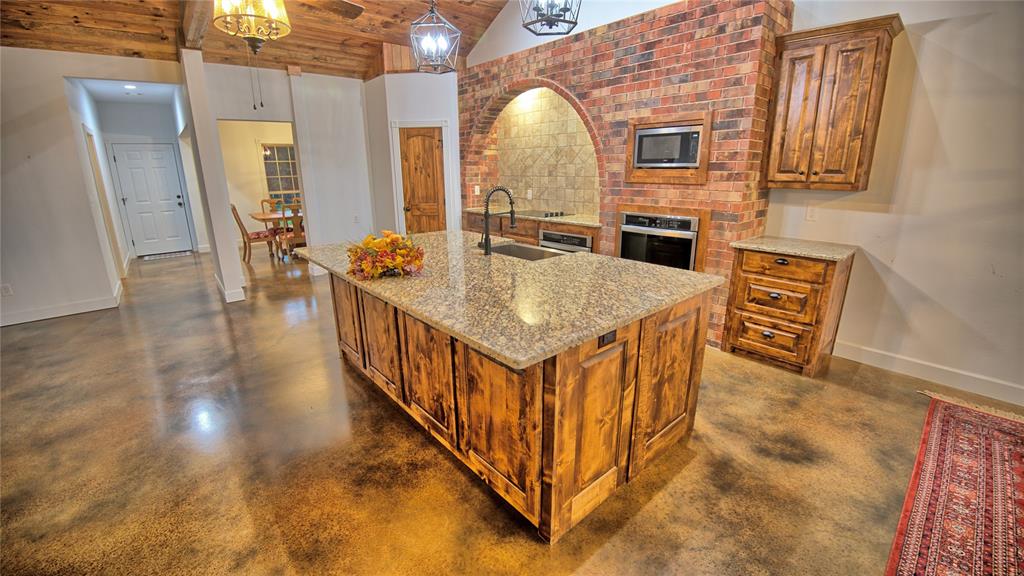 2930 North Greenbrier Road Nocona, TX 76255 - Photo 7 of 40 a view of a kitchen from a hallway