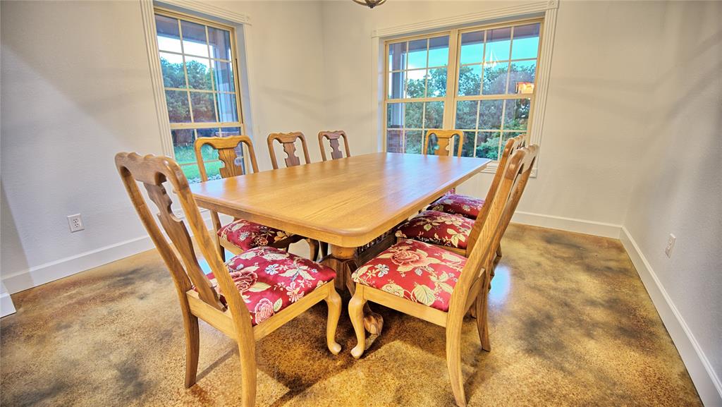2930 North Greenbrier Road Nocona, TX 76255 - Photo 10 of 40 a view of a dining room with furniture and wooden floor
