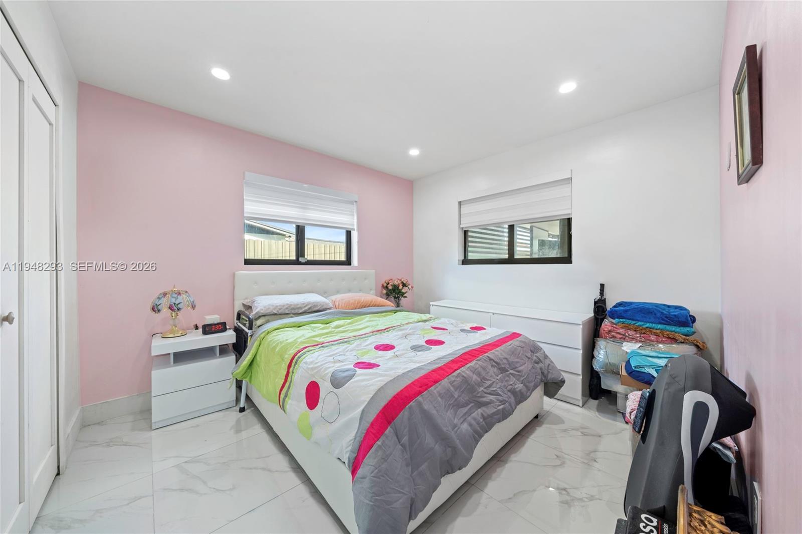 7874 Northwest 175th Street Hialeah, FL 33015 - Photo 13 of 19 a bedroom with a bed a desk and chair