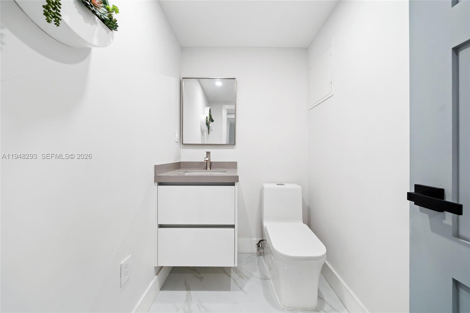 7874 Northwest 175th Street Hialeah, FL 33015 - Photo 16 of 19 a white toilet sitting next to a bathroom sink