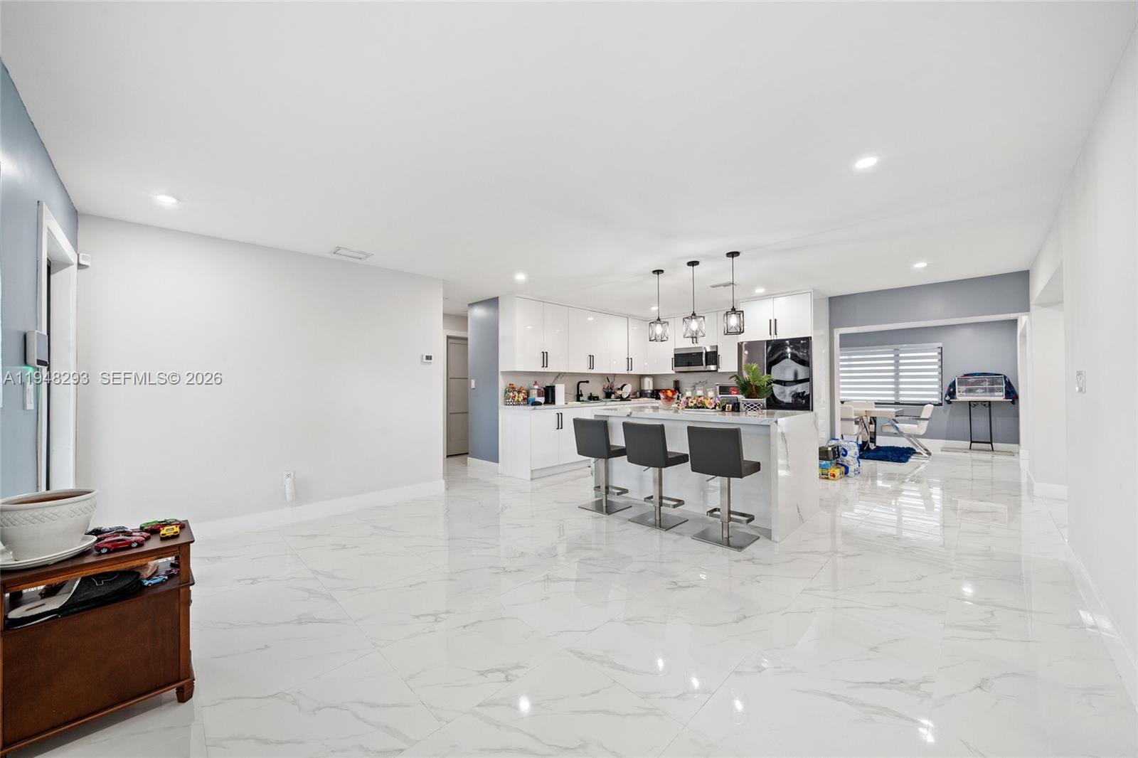 7874 Northwest 175th Street Hialeah, FL 33015 - Photo 3 of 19 a kitchen with stainless steel appliances kitchen island granite countertop a sink and cabinets