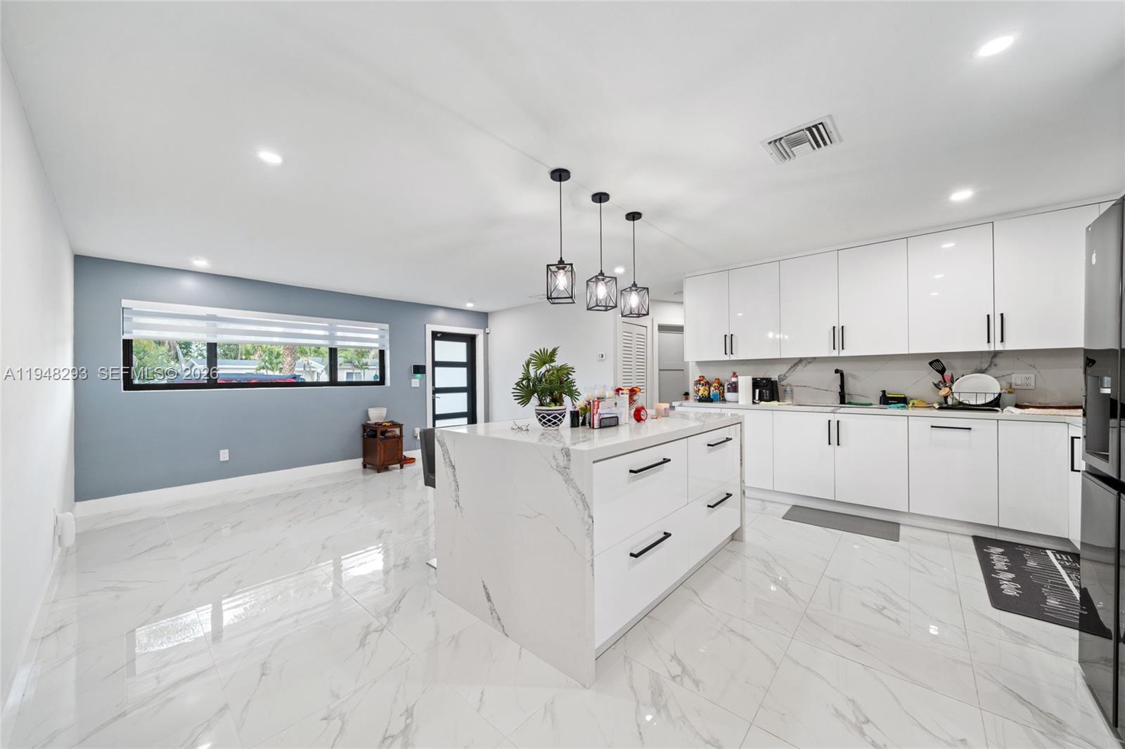 7874 Northwest 175th Street Hialeah, FL 33015 - Photo 6 of 19 a kitchen with white cabinets and white appliances