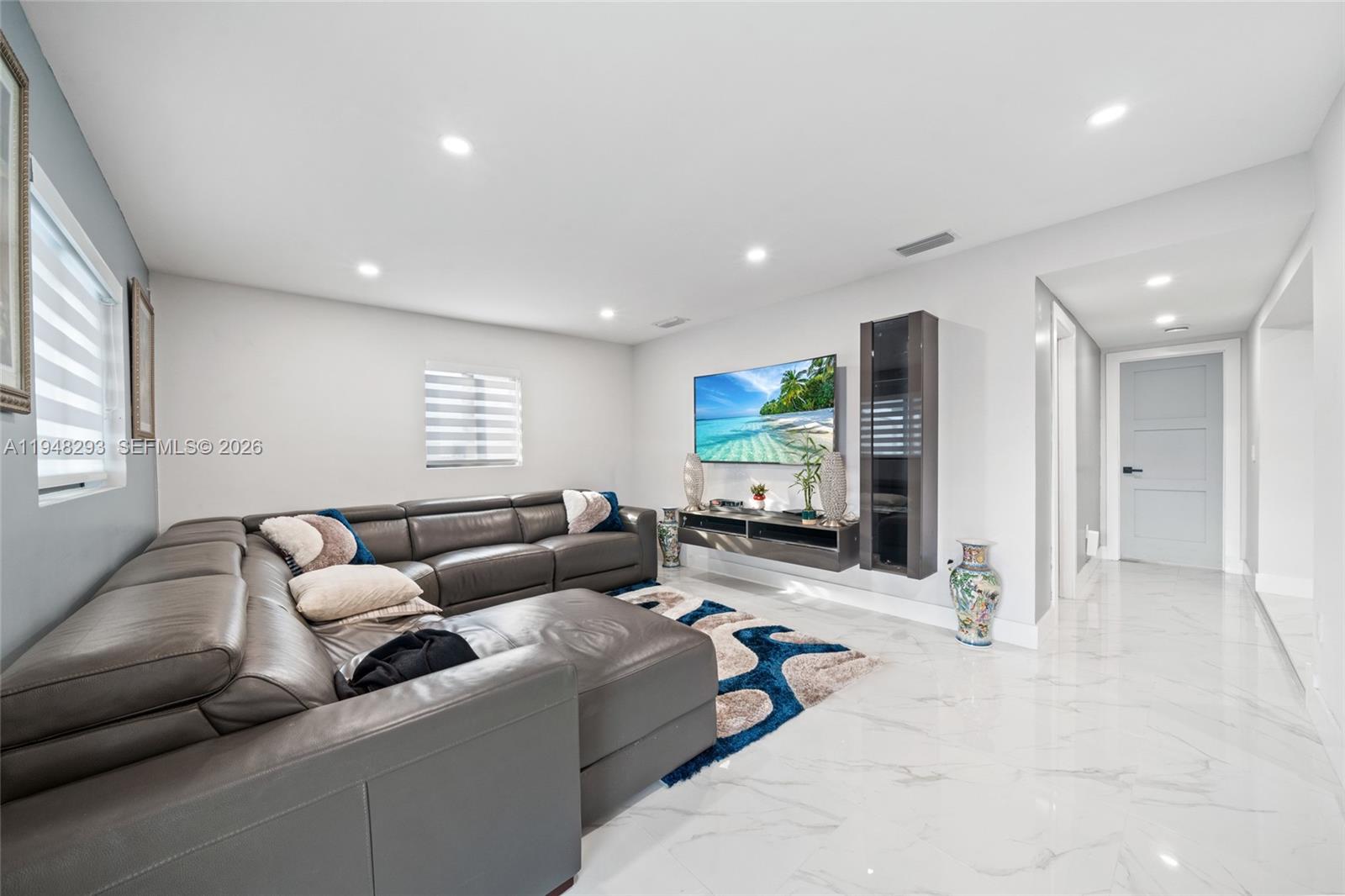 7874 Northwest 175th Street Hialeah, FL 33015 - Photo 9 of 19 a living room with furniture and a flat screen tv