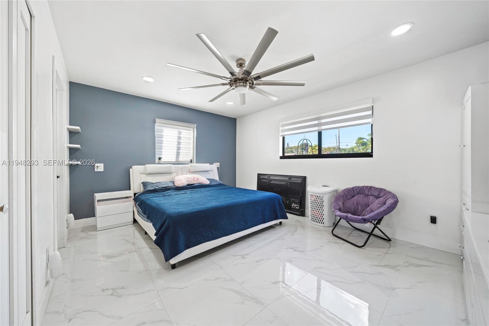 7874 Northwest 175th Street Hialeah, FL 33015 - Photo 10 of 19 a living room with furniture a ceiling fan and a rug