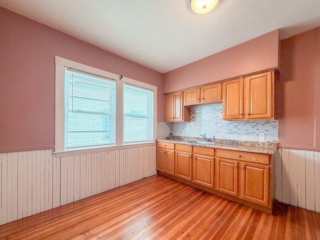 21 St Marks Road Boston, MA 02124 - Photo 7 of 30 a kitchen with granite countertop wooden floors a sink and granite counter tops