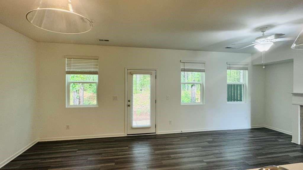 4078 Haleston Road Duluth, GA 30097 - Photo 5 of 25 an empty room with wooden floor and windows