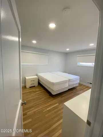 a bedroom with a bed and a night stand
