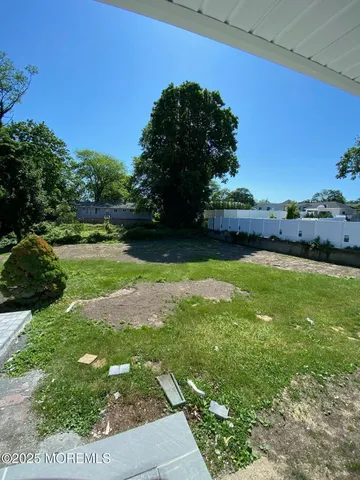a view of yard with swimming pool and green space