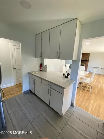 a kitchen with a sink cabinets and appliances