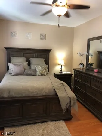 a bedroom with a bed and a night stand