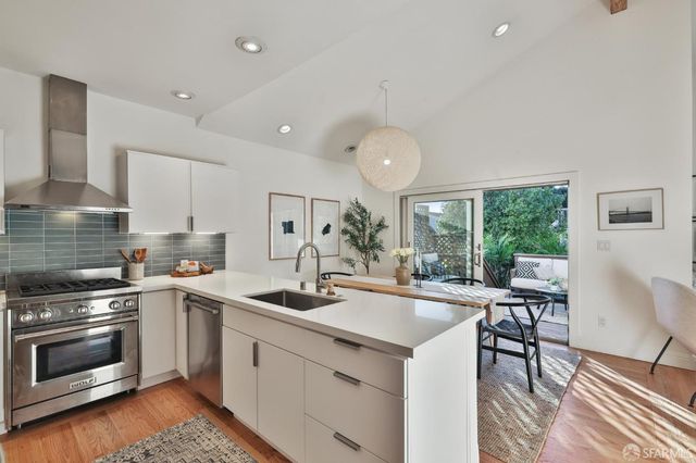 a kitchen with a sink stove and refrigerator