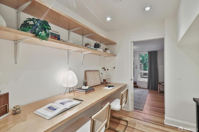 a bedroom with a bed and large window with chair