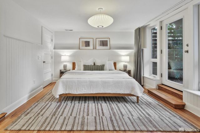 a spacious bathroom with a granite countertop sink a toilet a mirror and shower