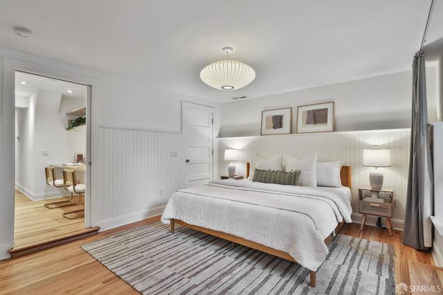 a bathroom with a granite countertop sink a toilet a mirror and shower