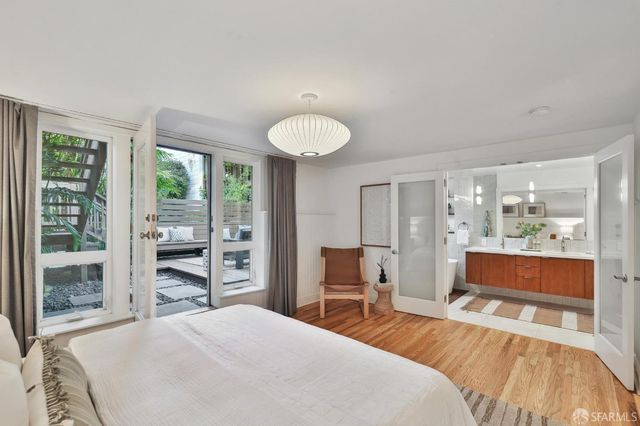 a bedroom with bed and a large window