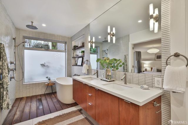 a balcony with wooden floor table and chairs