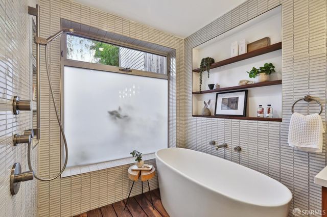 a view of a patio with couches chairs and wooden floor