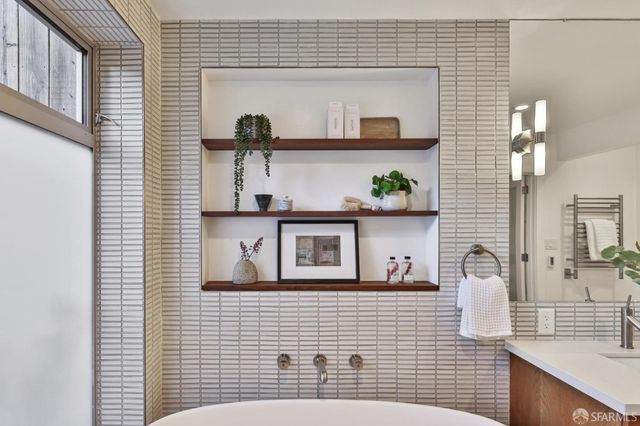 a view of a patio with couches table and chairs and potted plants