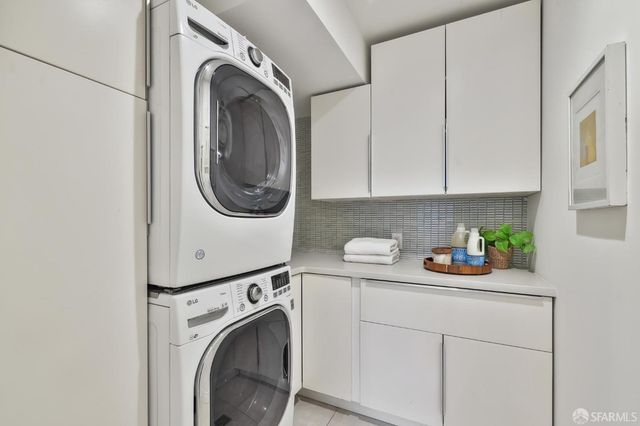 a view of a house with a small yard and wooden fence
